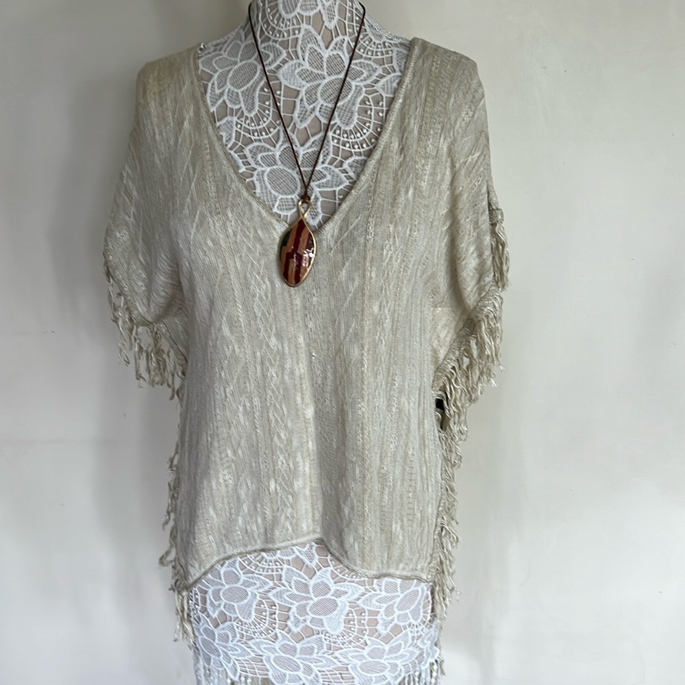 Say What. Cream color Fringe High/ Low Top with v-neck front and back.